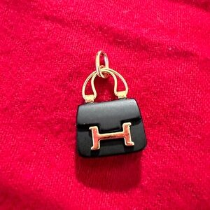Unbranded 18k pure gold Black Mini Bag amulet 
Not gold plated stamped of AU750
